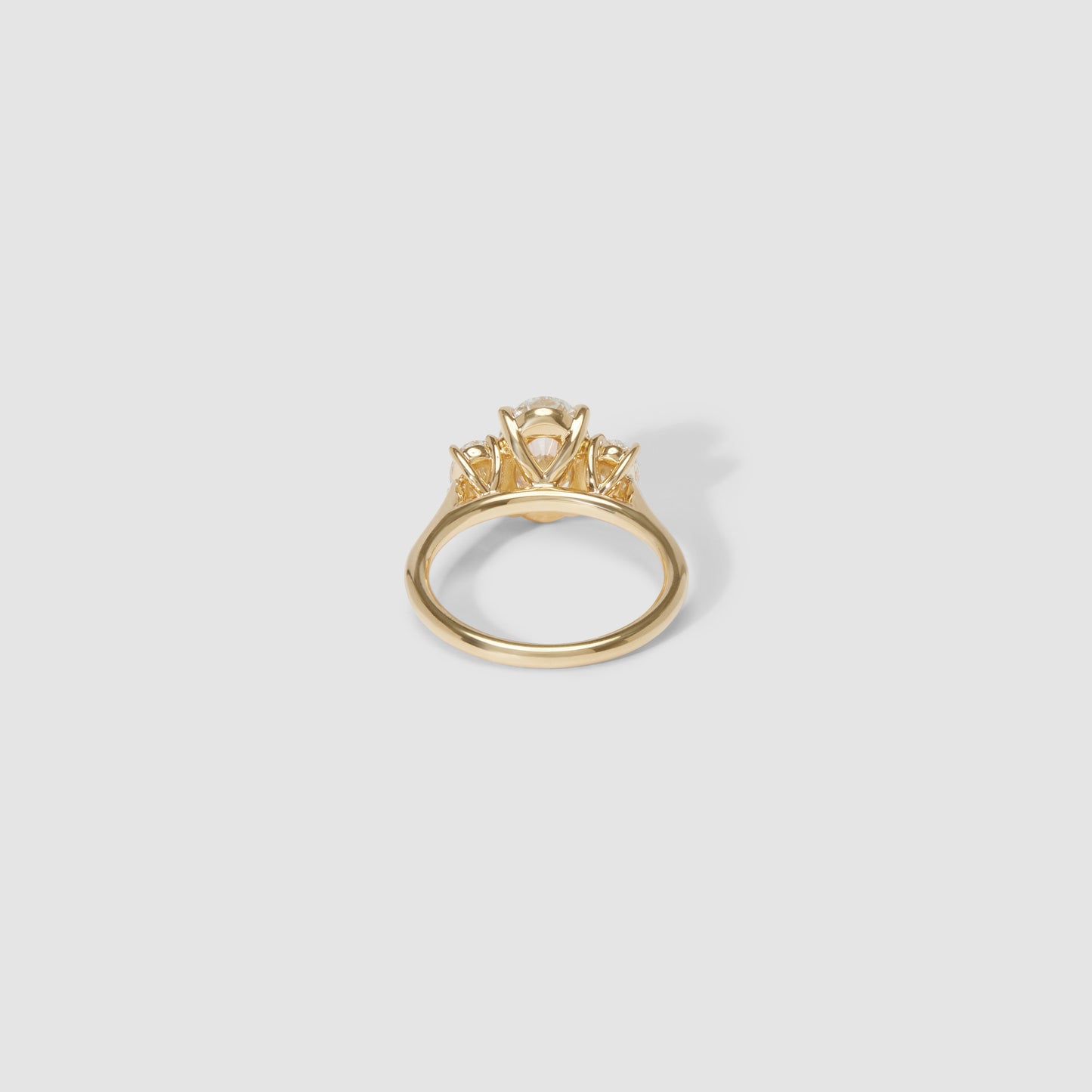 Gold engagement ring with a classic solitaire diamond setting on a plain band, showcasing timeless elegance and luxury jewellery design.