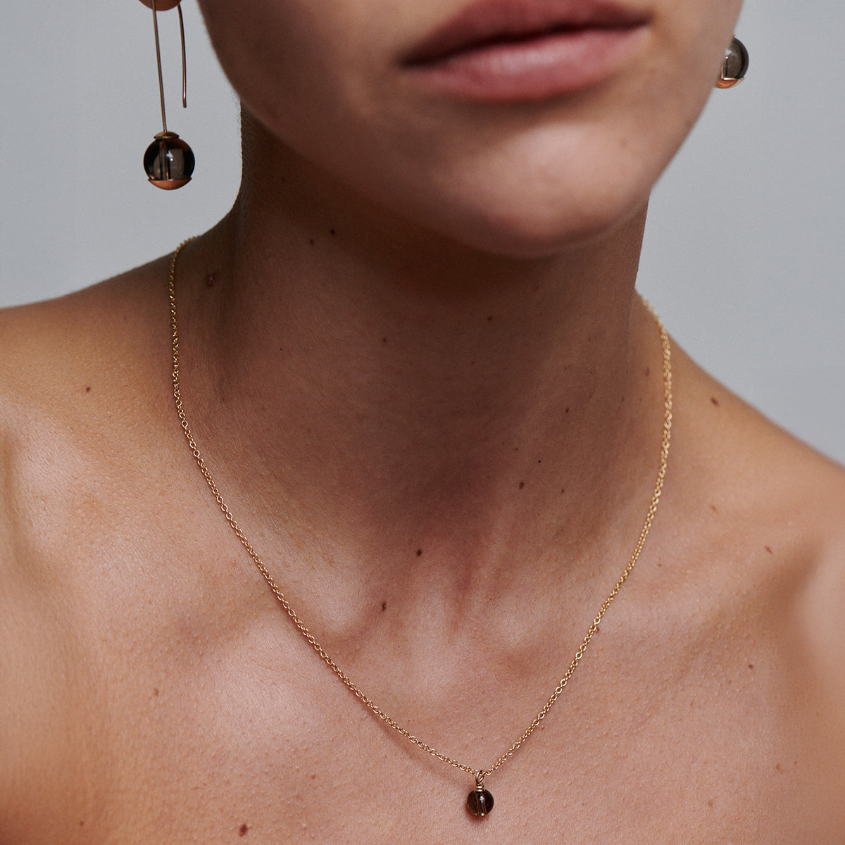 [text overlay: Model wears 45cm necklace] 