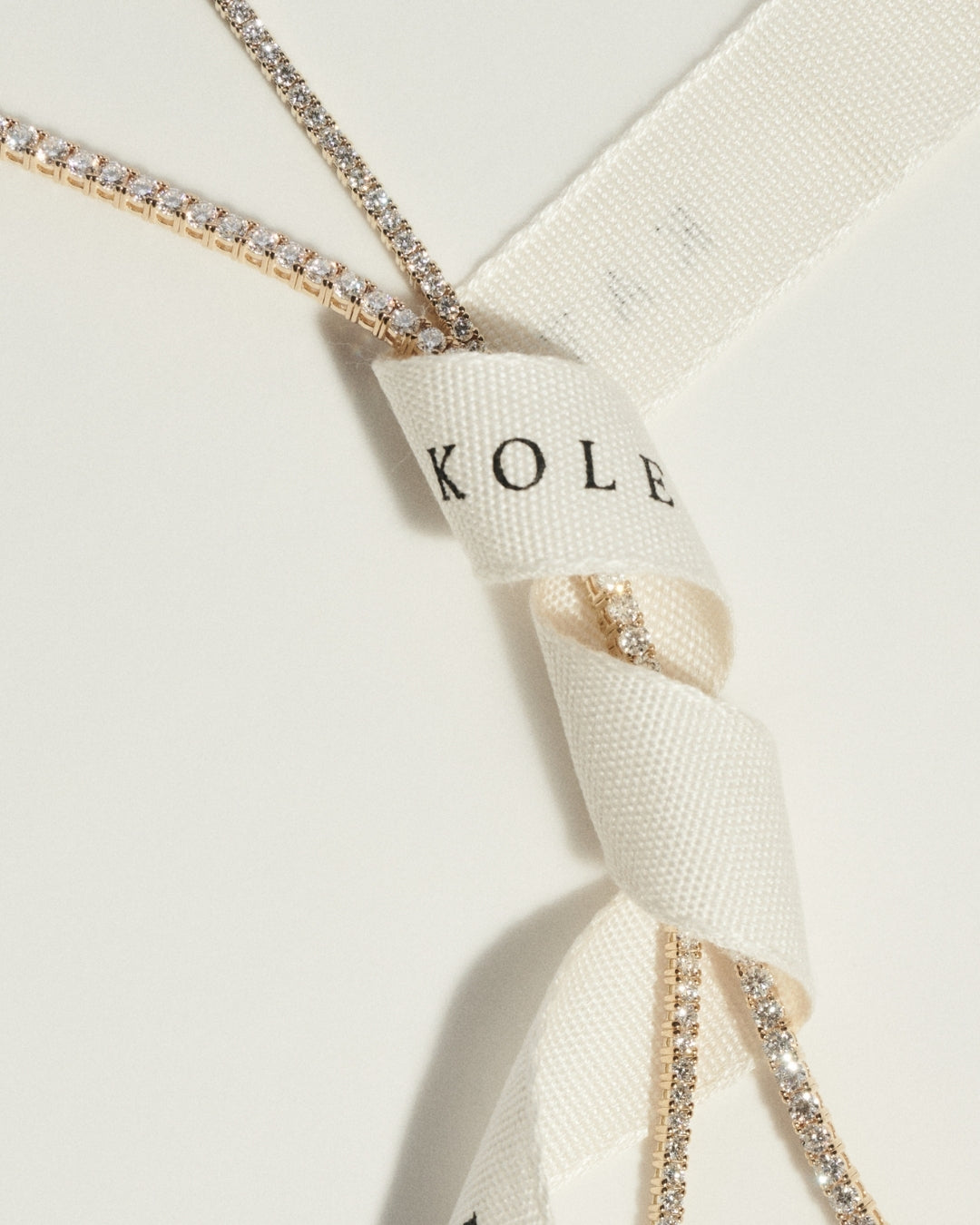 Tennis necklace with diamond accents on a white background