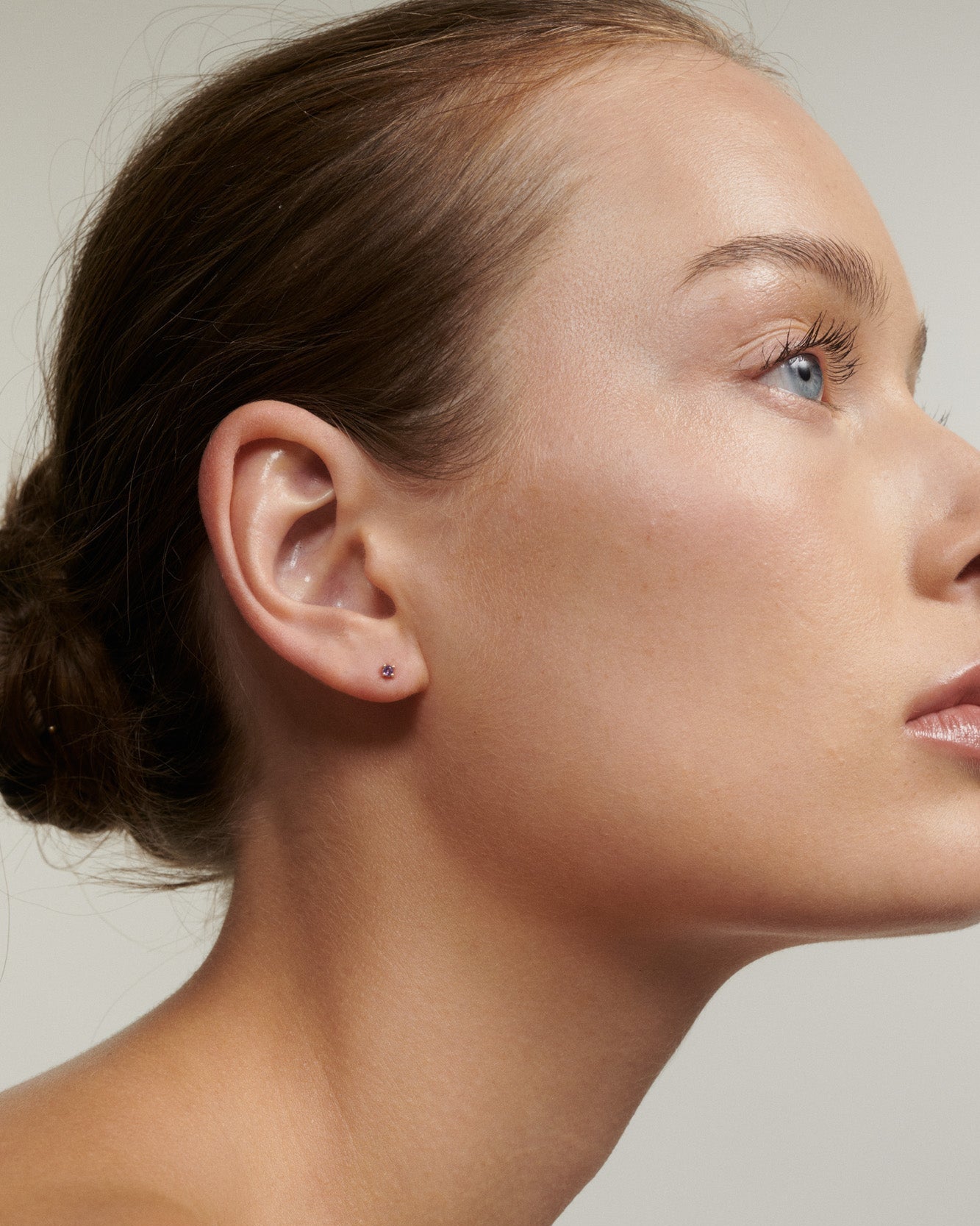 Model wearing a 9ct gold amethyst birthstone stud
