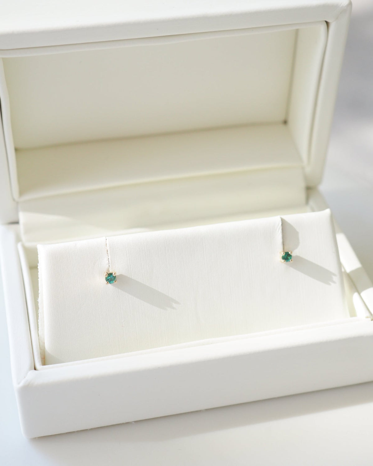 9ct gold birthstone studs in a jewellery box