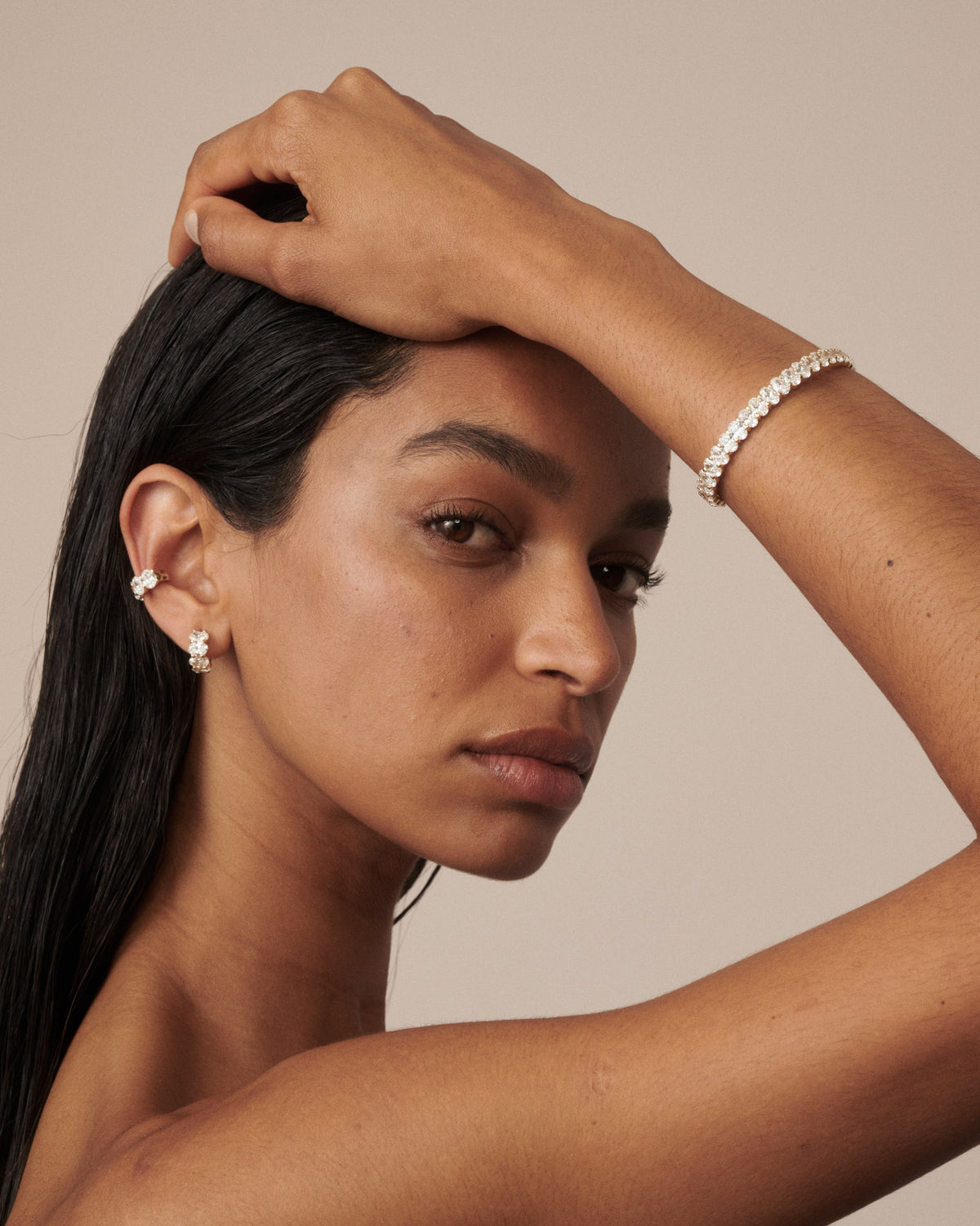 Lab-grown diamond bracelet on wrist with continuous oval stone row