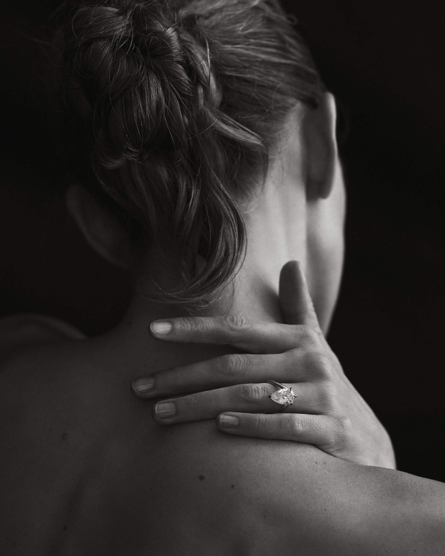 Kate & Kole diamond ring on hand, worn on the shoulder.