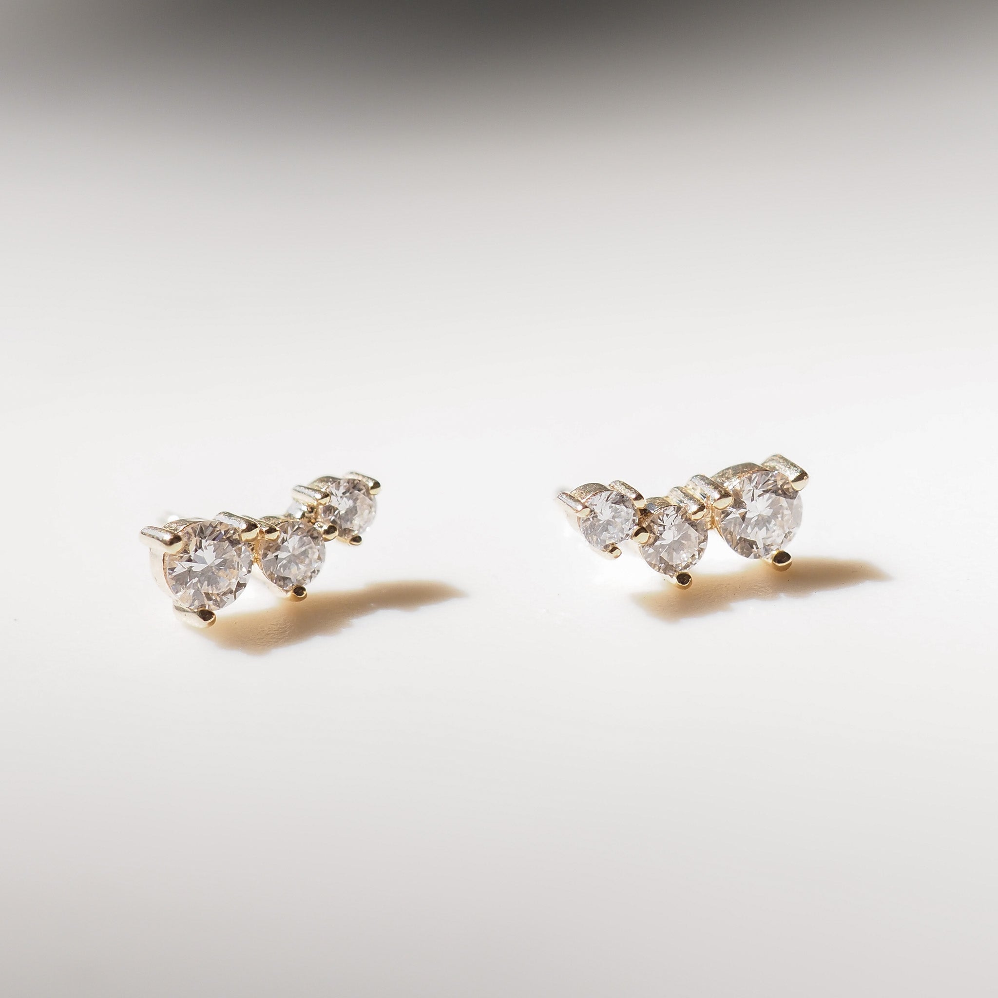 Pair of diamond earrings on a light gray background
