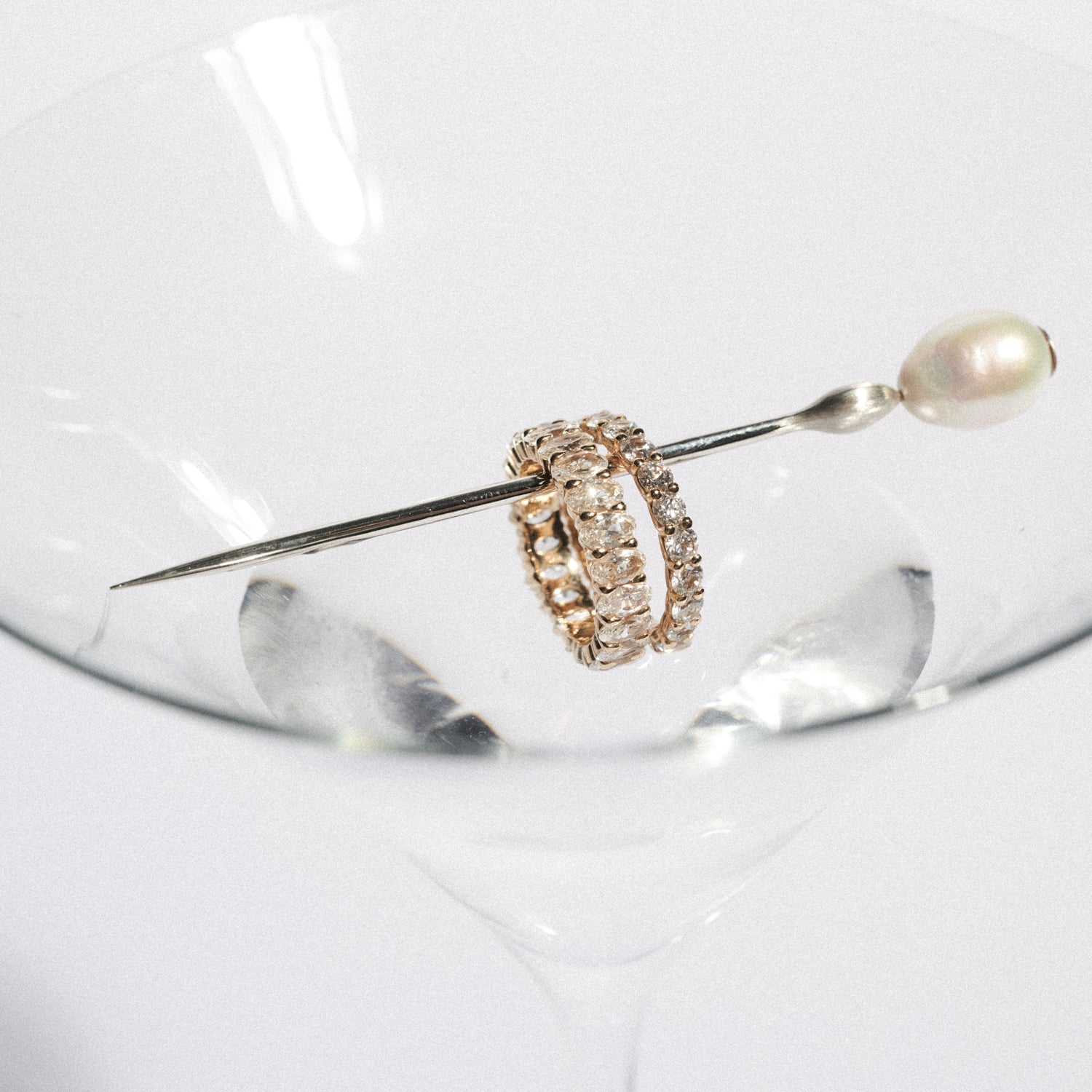 Gold diamond rings with pearl on a white backgrounds