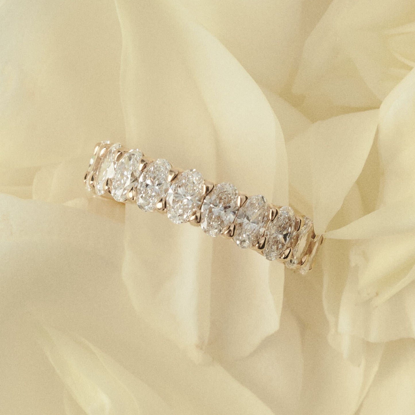 Diamond ring on a soft, light-colored fabric background