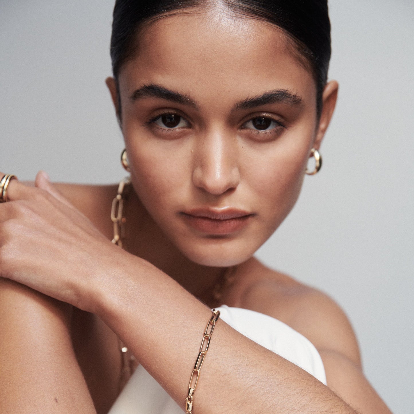 Model wearing gold link bracelet