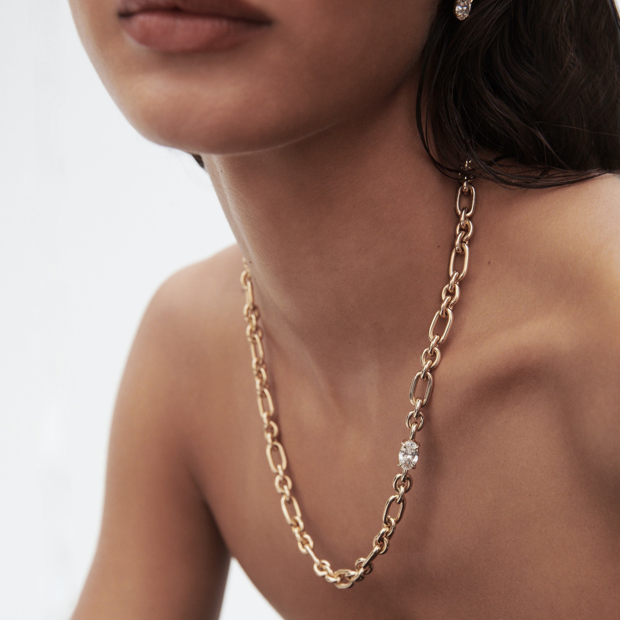 Woman wearing a luxury gold chain necklace with a diamond accent, showcasing elegance. Perfect for high-end jewellery enthusiasts. [text overlay: 2ct Lab Grown Diamond]  [text colour: #000000]