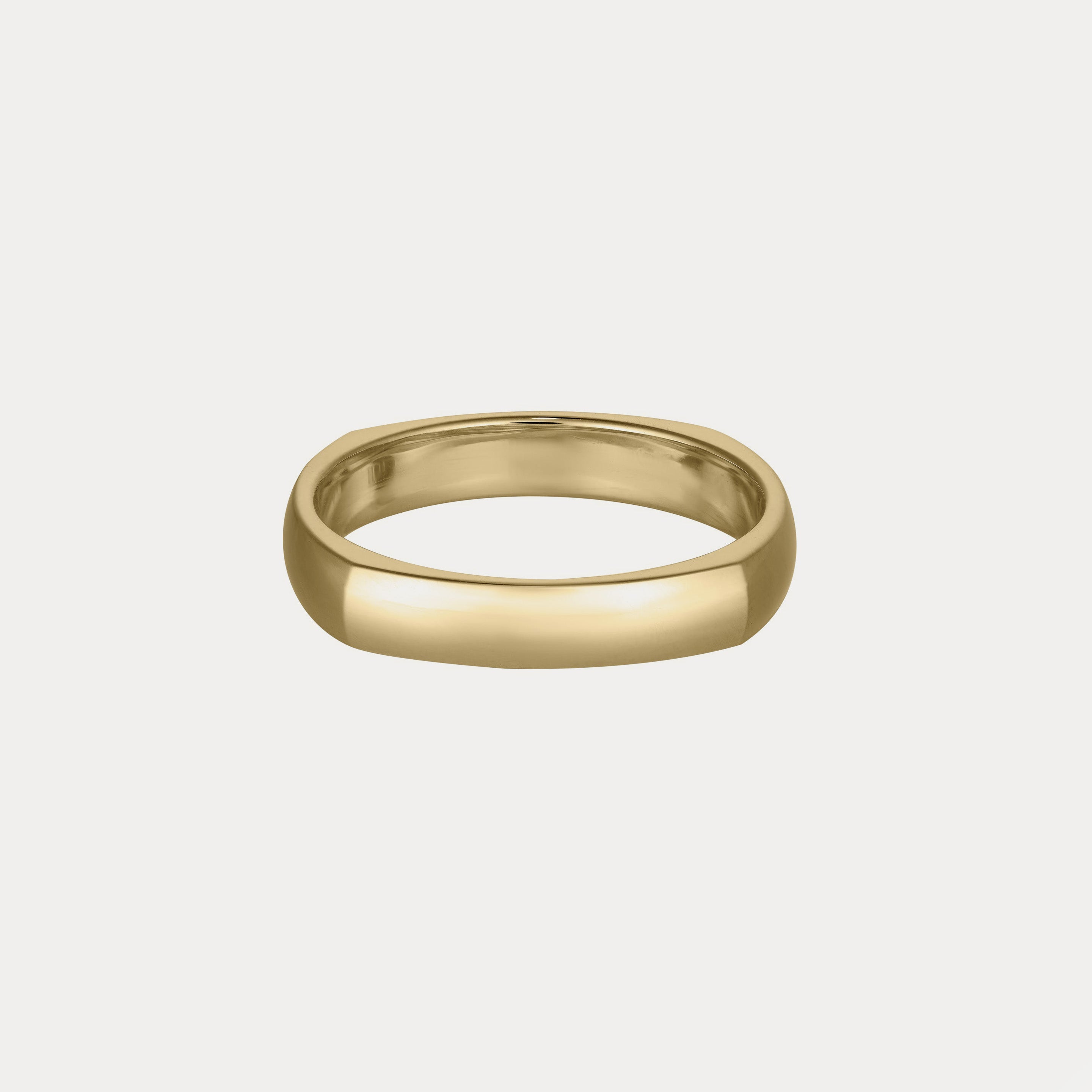 Gold polished domed ring with a smooth, rounded surface on a plain white background, symbolising luxury and elegance in fine jewellery.
