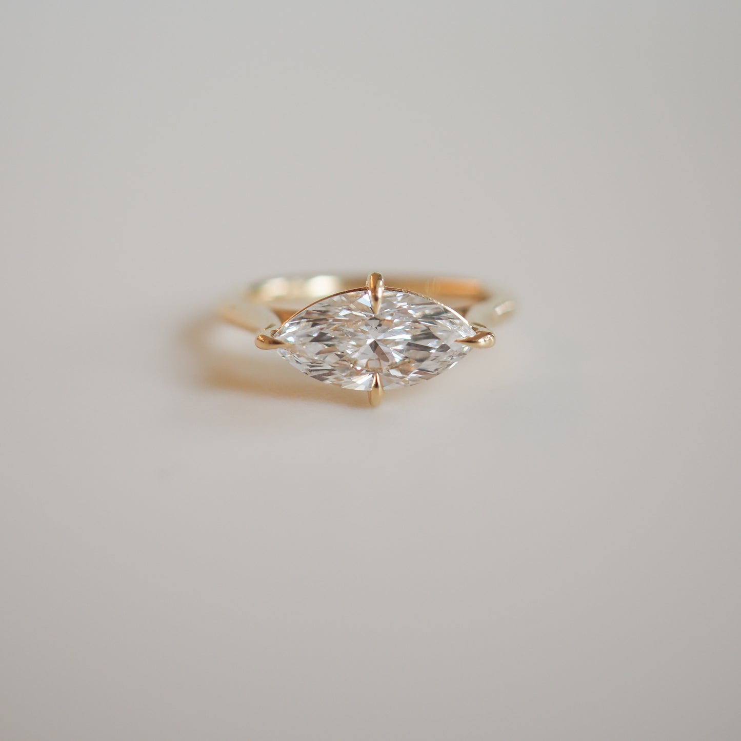Gold ring featuring a marquise-cut diamond, elegantly set on a minimalist band, showcasing luxury jewellery design.